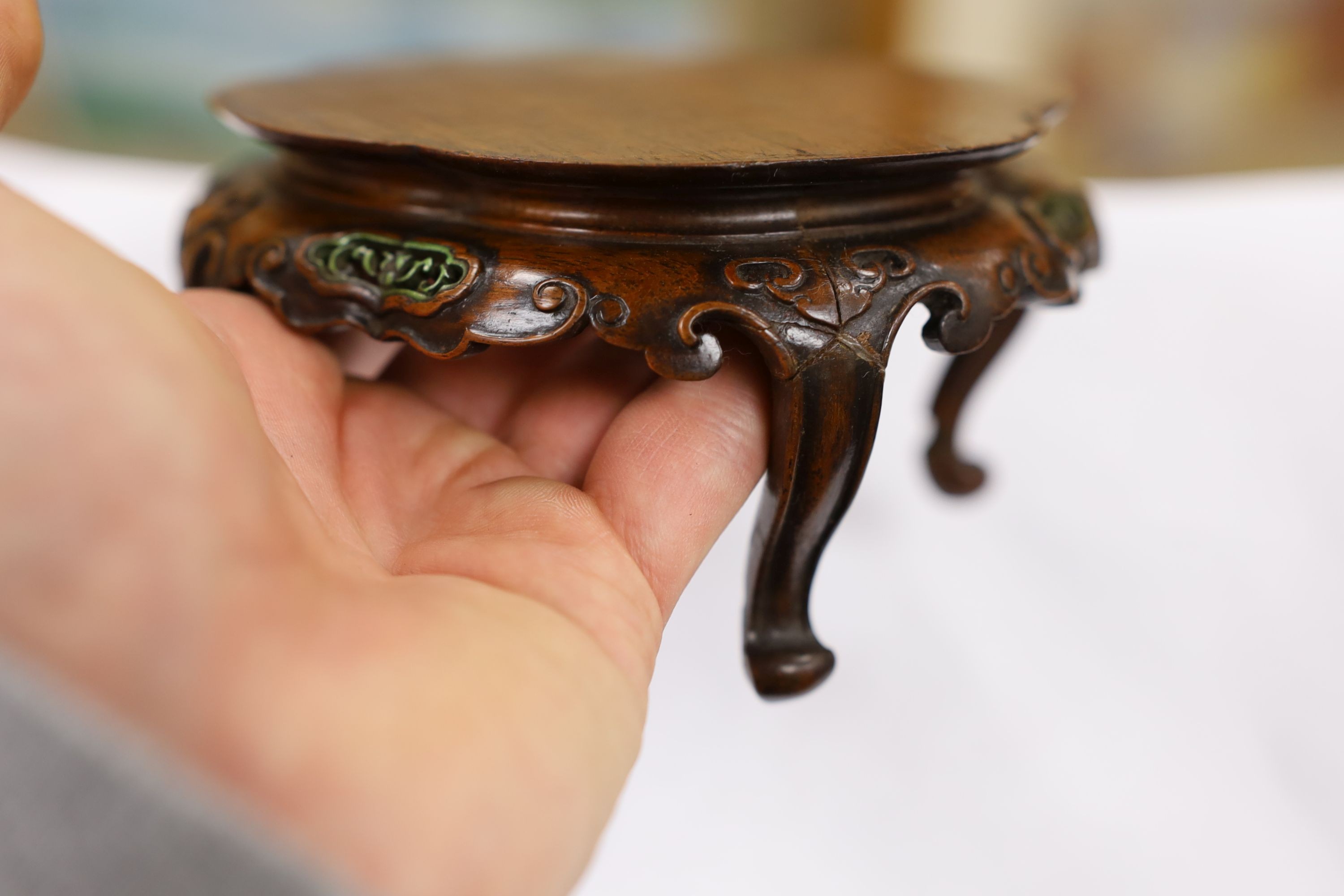 A fine Chinese oval hardwood and green stained Ivory inset stand, Qing dynasty, lacking stretcher, 15 cms wide.